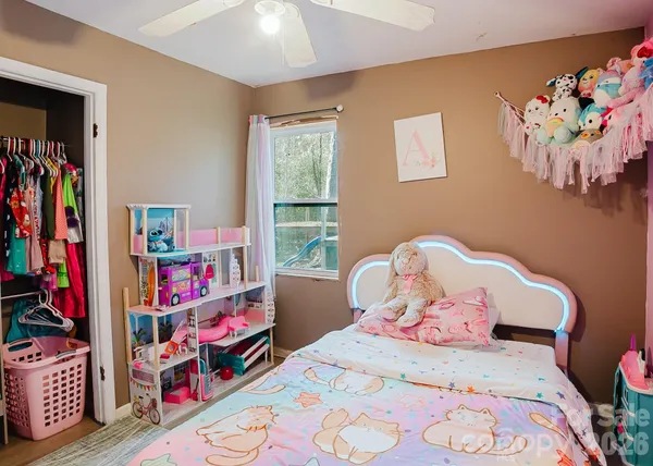 a bedroom with a bed and a wooden floor