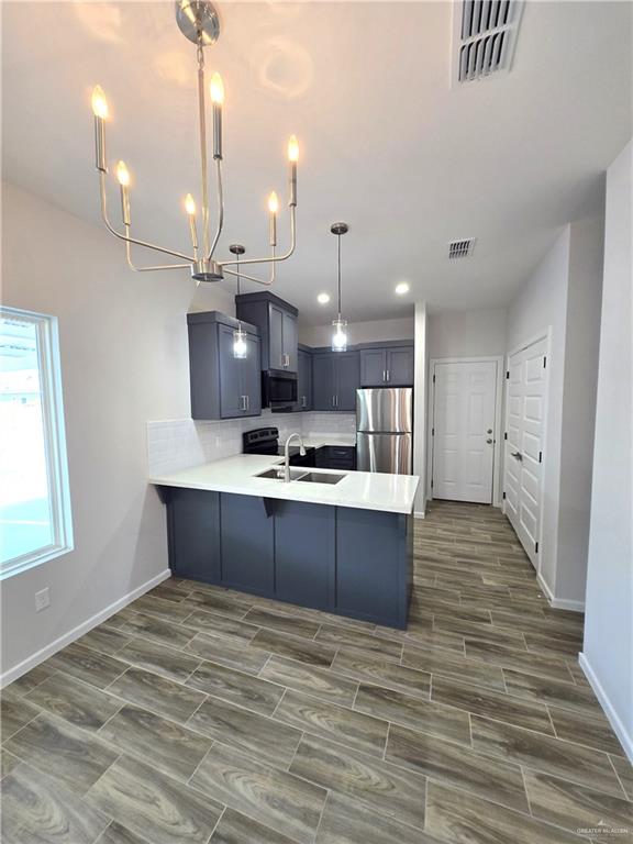 913 North Clarence Avenue, Unit 3 Edinburg, TX 78541 - Photo 2 of 11 a view of kitchen and kitchen island