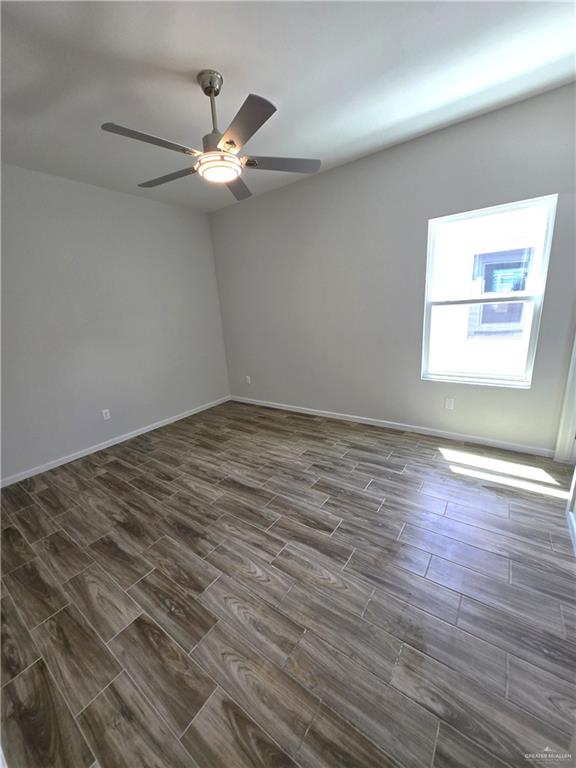 913 North Clarence Avenue, Unit 3 Edinburg, TX 78541 - Photo 7 of 11 an empty room with wooden floor fan and windows
