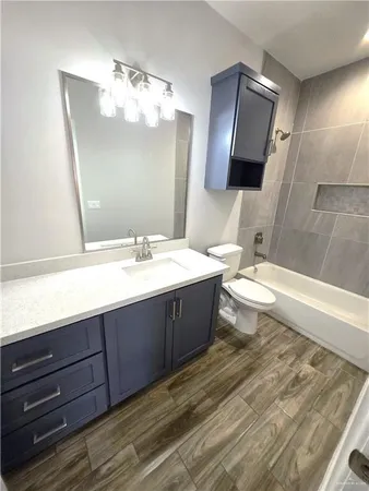 a bathroom with a sink a large mirror and a bathtub