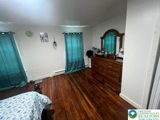 731 North Front Street Allentown, PA 18102 - Photo 13 of 22 a bedroom with a bed and a mirror on the wall