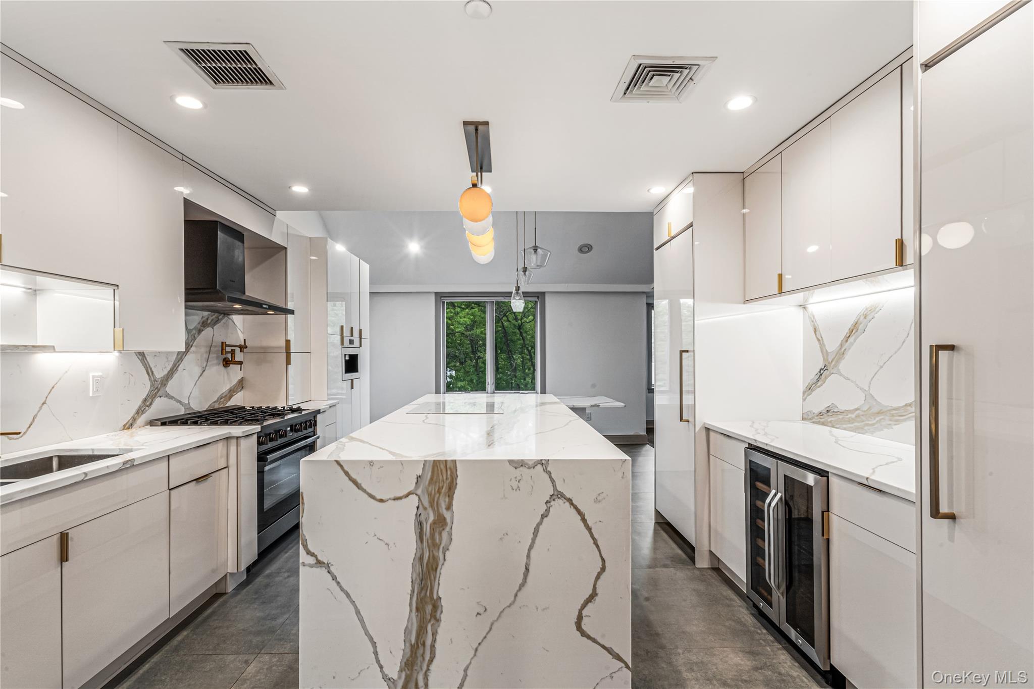 171 Great Neck Road, Unit 4R Great Neck, NY 11021 - Photo 7 of 27 a kitchen with stainless steel appliances a sink stove and refrigerator