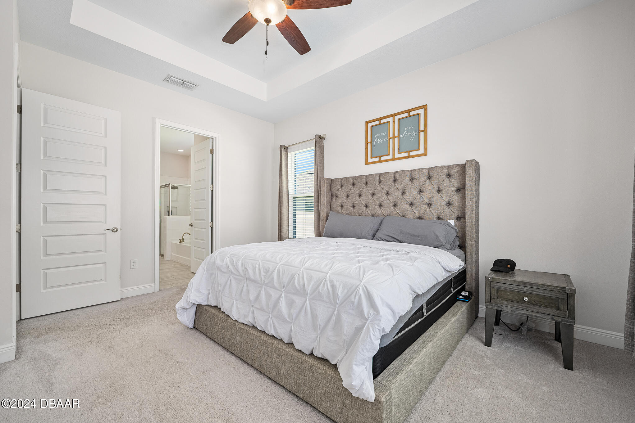 295 Cypress Trail Drive Ormond Beach, FL 32174 - Photo 15 of 67 a bedroom with a bed and a chandelier