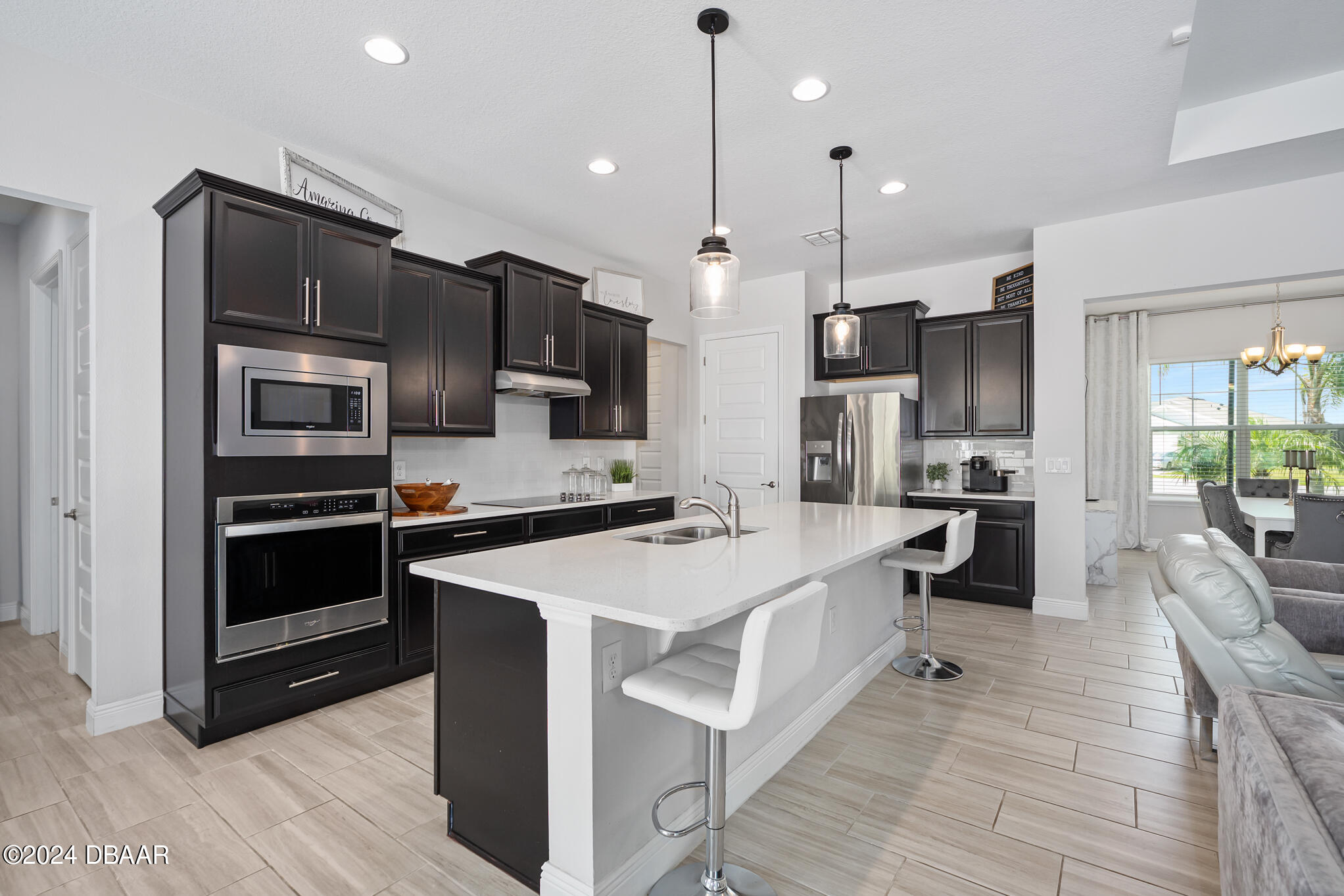 295 Cypress Trail Drive Ormond Beach, FL 32174 - Photo 20 of 67 a kitchen with stainless steel appliances kitchen island granite countertop a large stove a sink dishwasher and a refrigerator with wooden floor