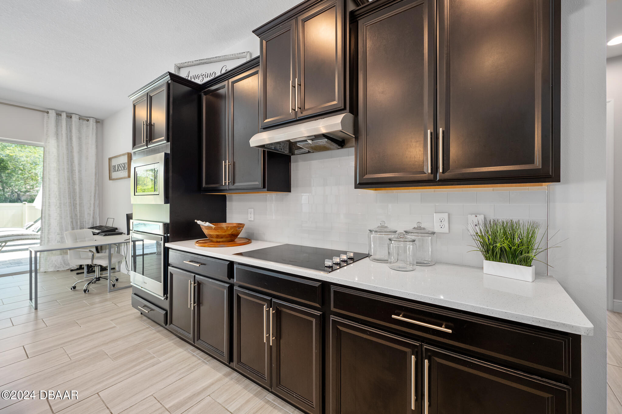295 Cypress Trail Drive Ormond Beach, FL 32174 - Photo 22 of 67 a kitchen with stainless steel appliances a sink stove and cabinets