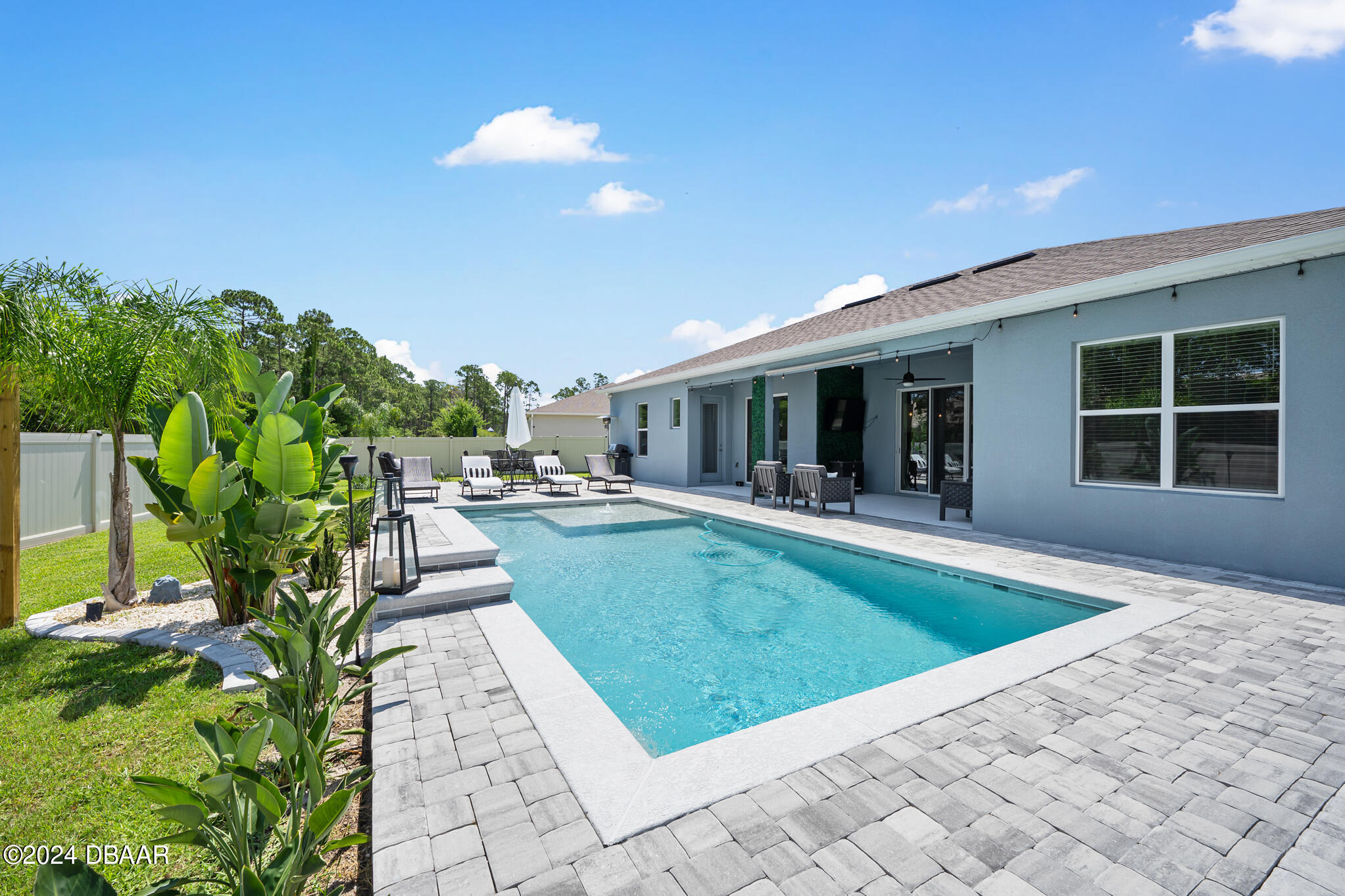 295 Cypress Trail Drive Ormond Beach, FL 32174 - Photo 28 of 67 a view of swimming pool with outdoor seating and deck in the back