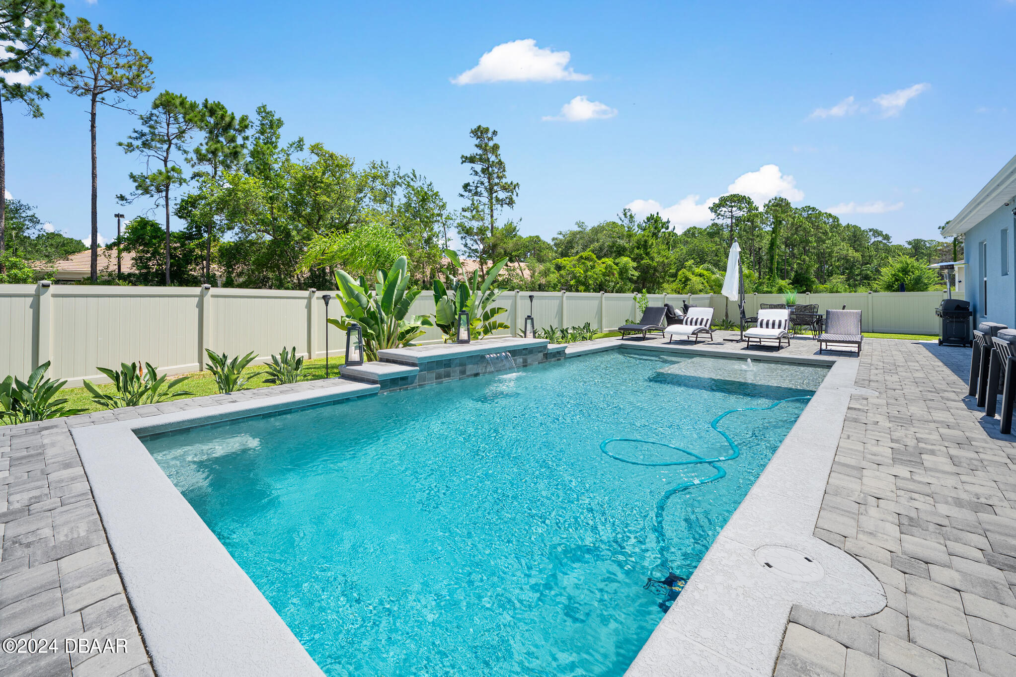 295 Cypress Trail Drive Ormond Beach, FL 32174 - Photo 30 of 67 a view of a swimming pool with a patio