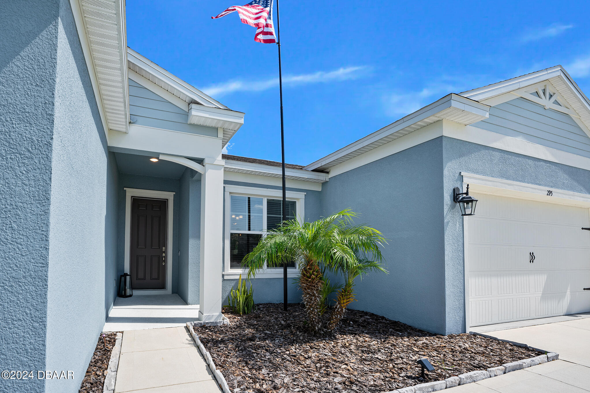 295 Cypress Trail Drive Ormond Beach, FL 32174 - Photo 3 of 67 a potted plant sitting in front of a house
