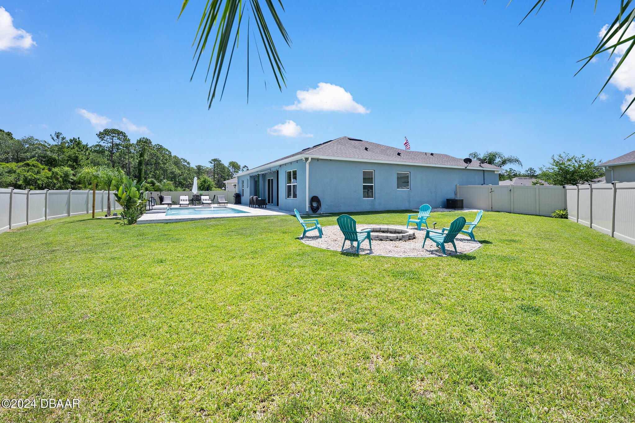 295 Cypress Trail Drive Ormond Beach, FL 32174 - Photo 35 of 67 a swimming pool with outdoor seating and yard