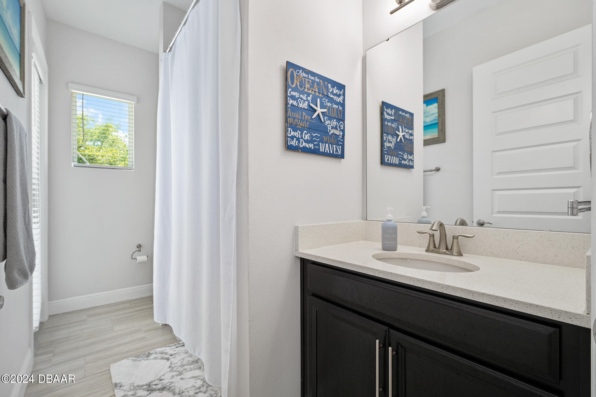 295 Cypress Trail Drive Ormond Beach, FL 32174 - Photo 37 of 67 a bathroom with a sink and a mirror
