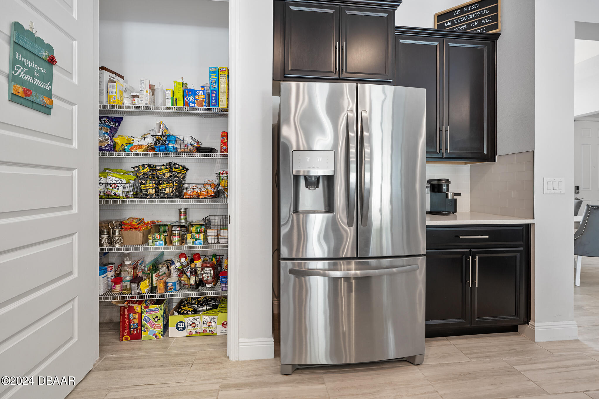 295 Cypress Trail Drive Ormond Beach, FL 32174 - Photo 41 of 67 a metallic refrigerator freezer sitting in a kitchen