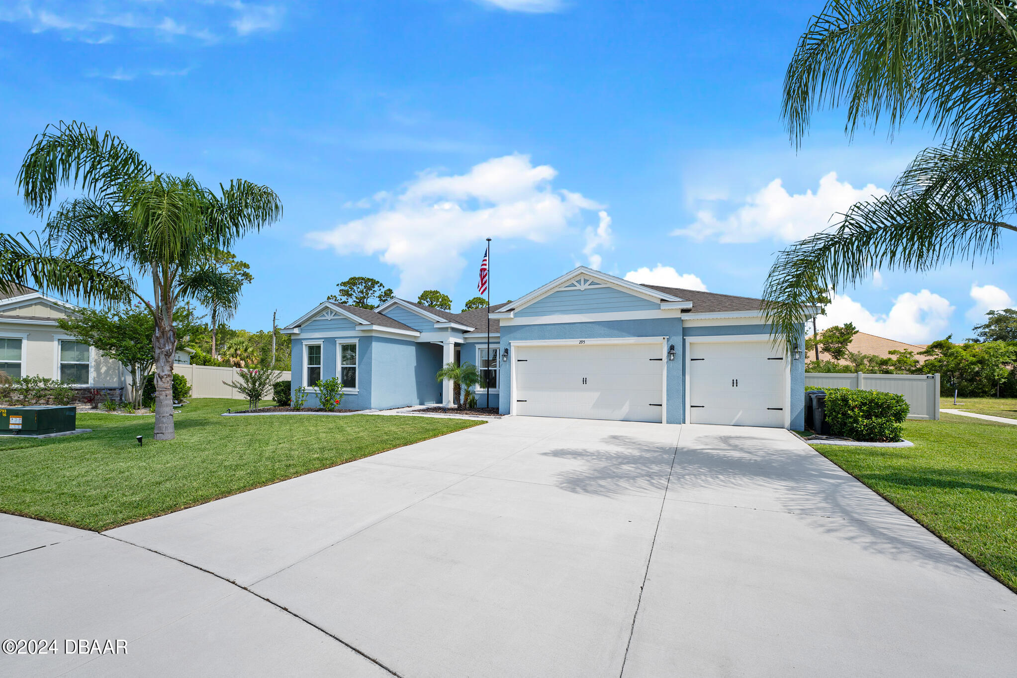 295 Cypress Trail Drive Ormond Beach, FL 32174 - Photo 63 of 67 a view of a white house with a yard and palm trees