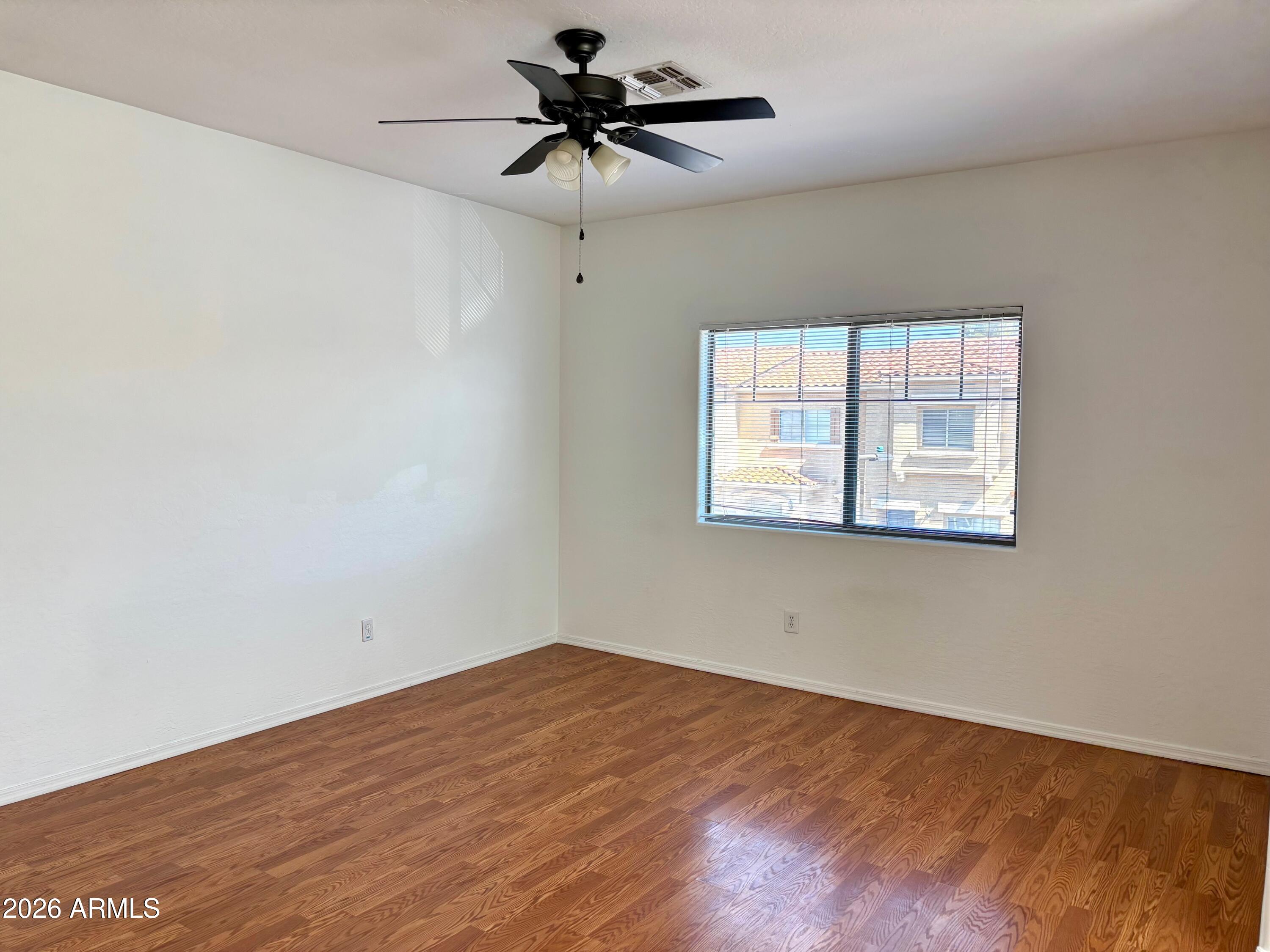 525 North Miller Road, Unit 239 Scottsdale, AZ 85257 - Photo 11 of 52 an empty room with a window and a ceiling fan
