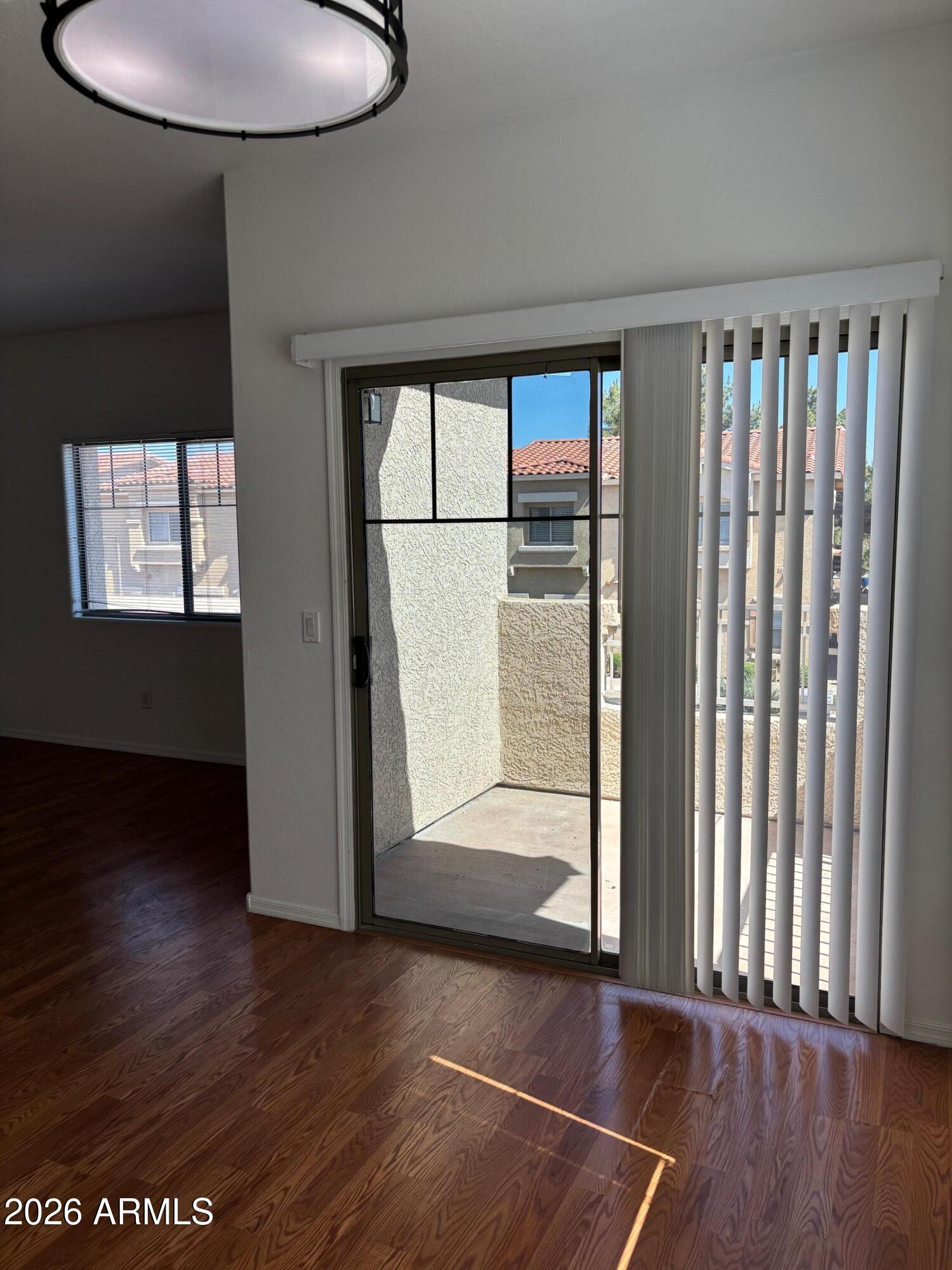 525 North Miller Road, Unit 239 Scottsdale, AZ 85257 - Photo 15 of 52 an empty room with wooden floor and windows