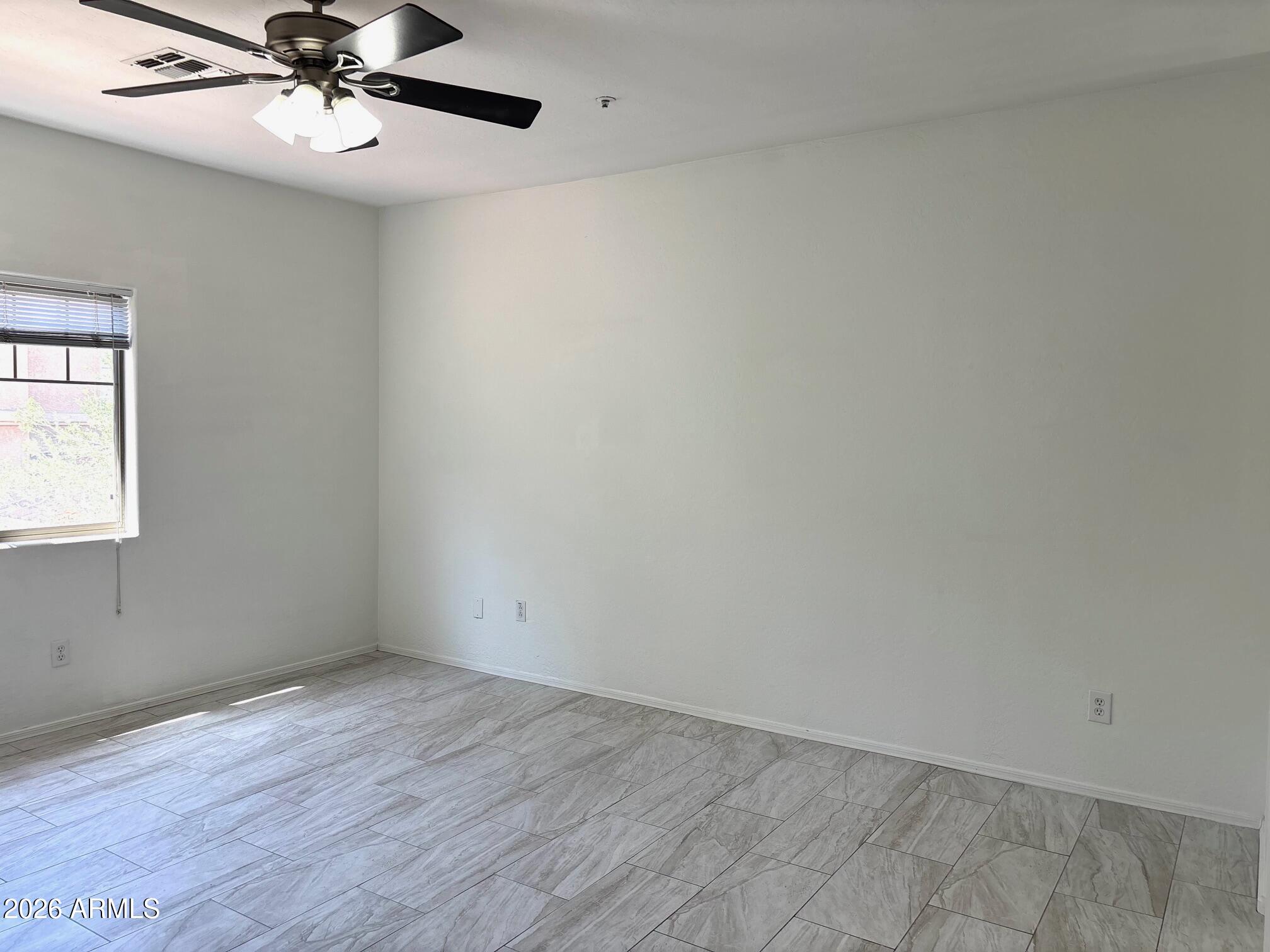 525 North Miller Road, Unit 239 Scottsdale, AZ 85257 - Photo 18 of 52 wooden floor in an empty room with a window