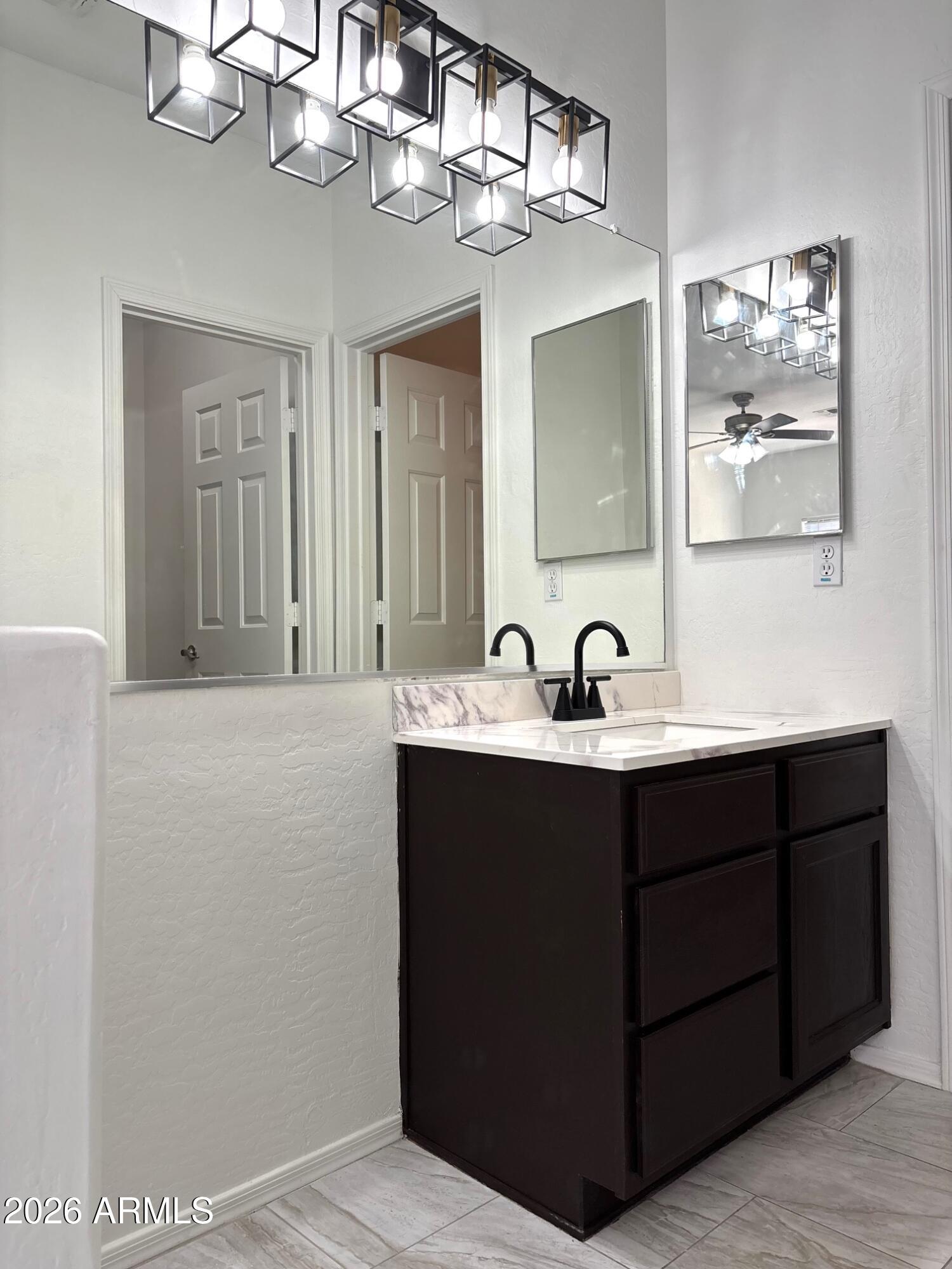 525 North Miller Road, Unit 239 Scottsdale, AZ 85257 - Photo 21 of 52 a bathroom with a sink vanity and a mirror