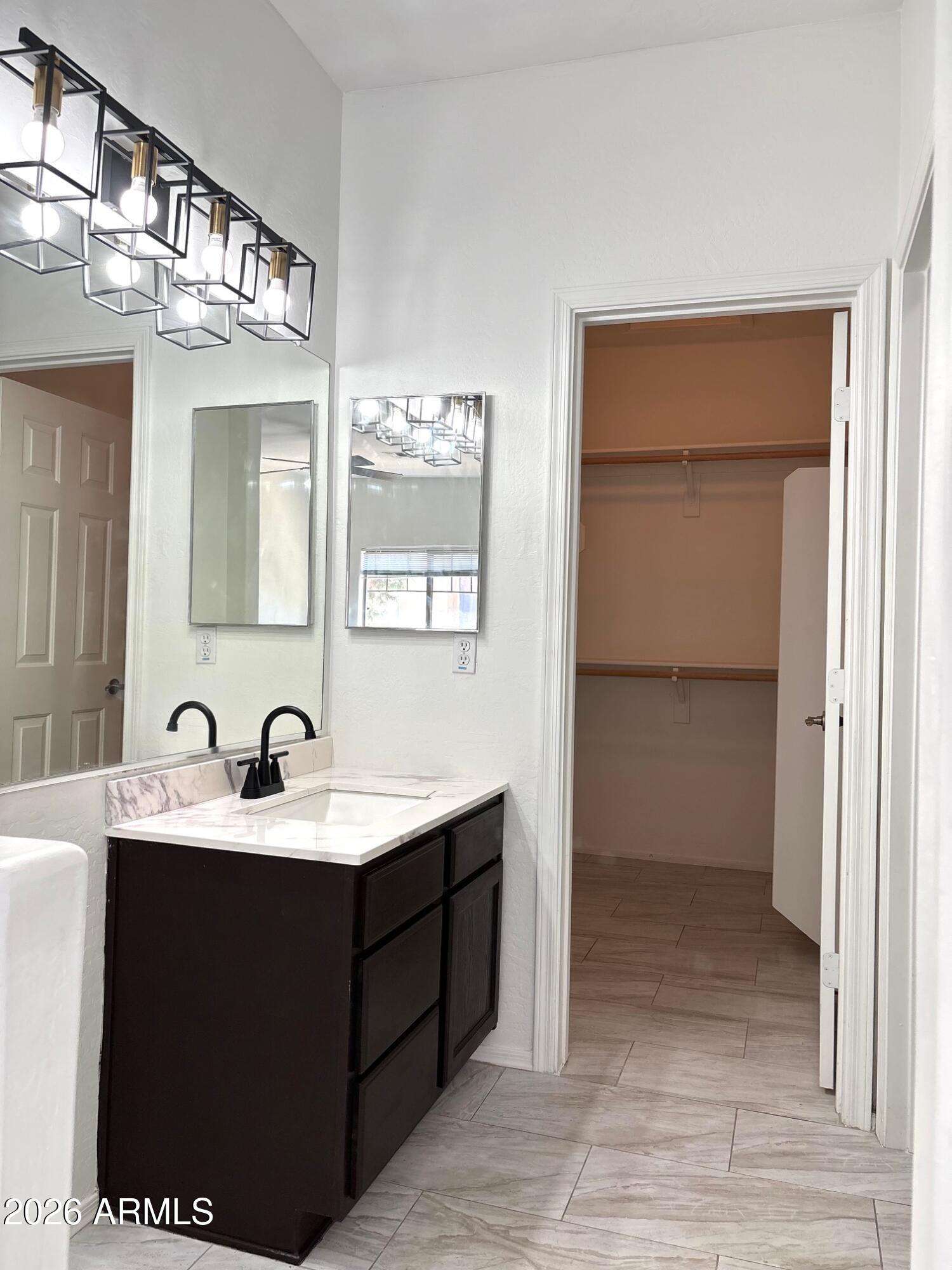 525 North Miller Road, Unit 239 Scottsdale, AZ 85257 - Photo 23 of 52 a bathroom with a sink and a mirror