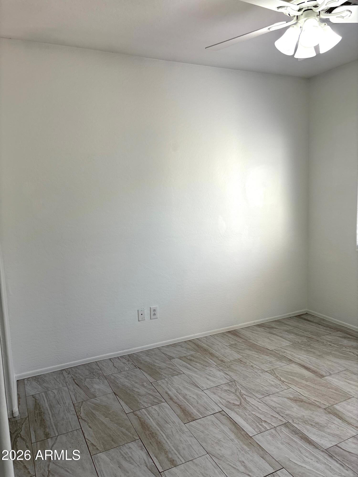 525 North Miller Road, Unit 239 Scottsdale, AZ 85257 - Photo 34 of 52 en empty room with wooden floor and windows
