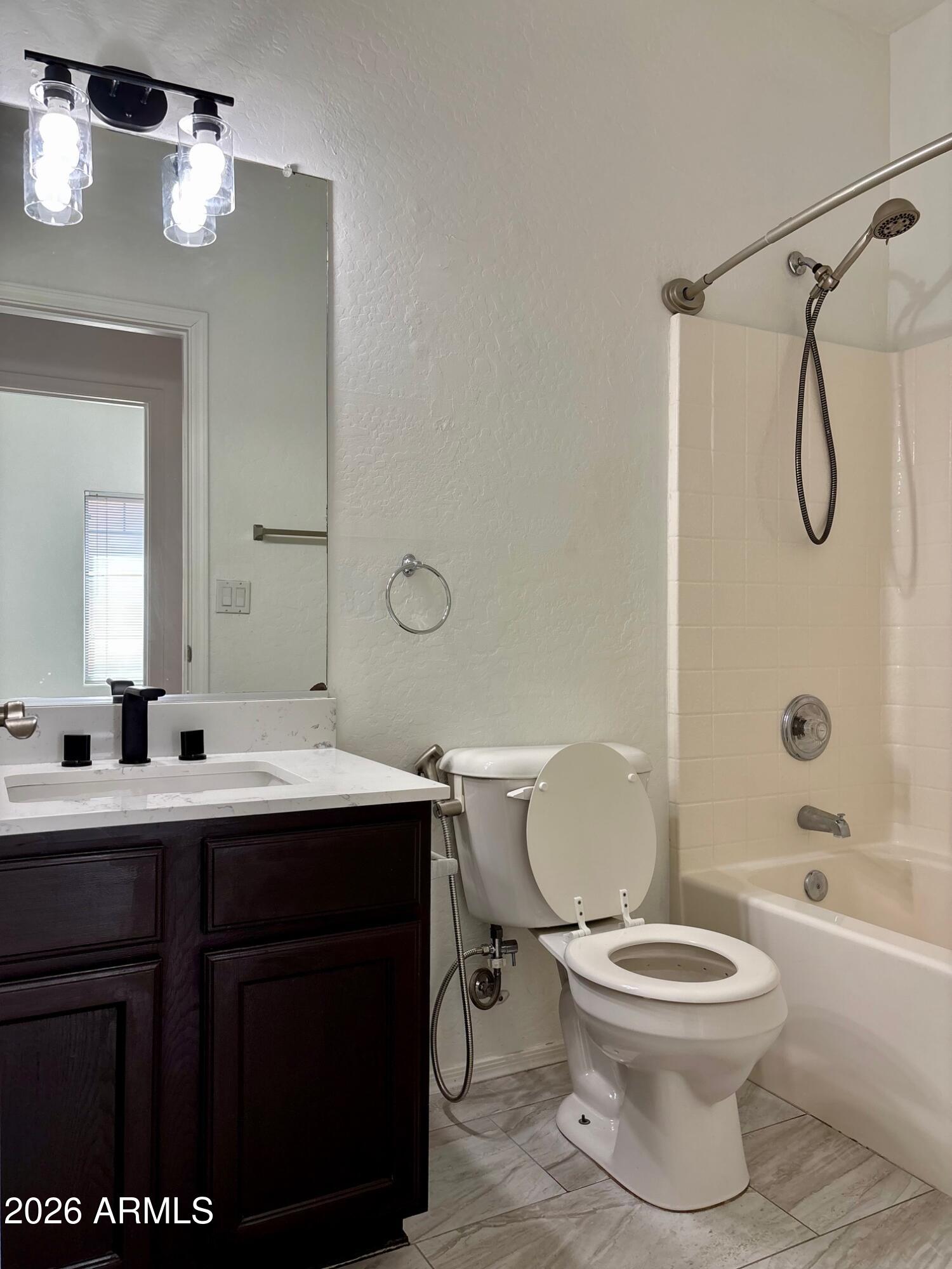 525 North Miller Road, Unit 239 Scottsdale, AZ 85257 - Photo 38 of 52 a bathroom with a toilet sink vanity granite tub and shower