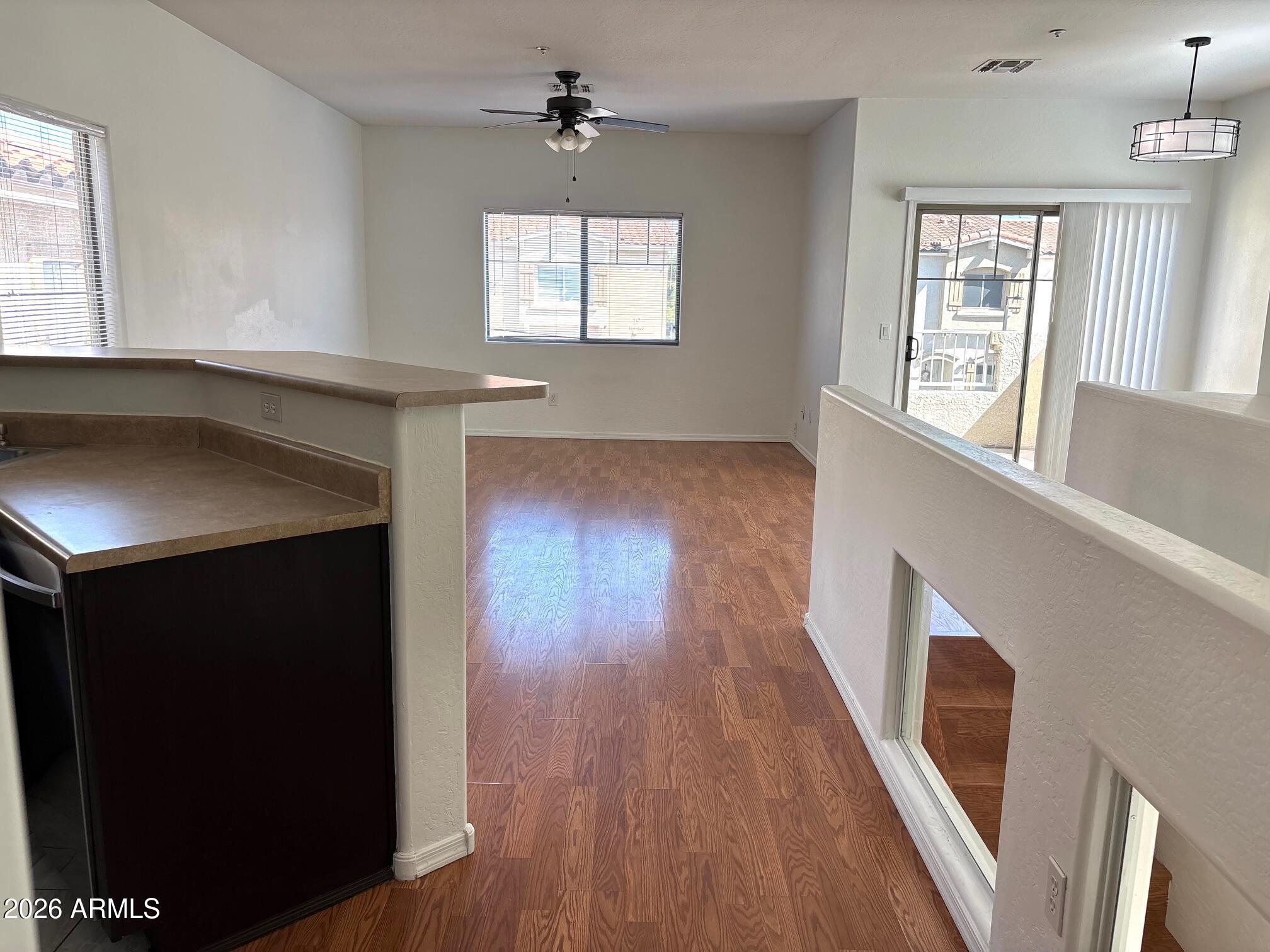 525 North Miller Road, Unit 239 Scottsdale, AZ 85257 - Photo 40 of 52 a view of an empty room with wooden floor and a window