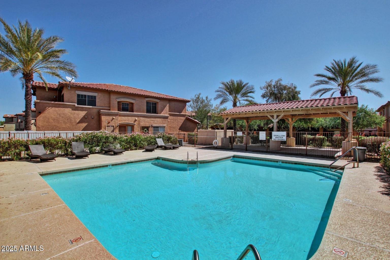 525 North Miller Road, Unit 239 Scottsdale, AZ 85257 - Photo 45 of 52 a view of a house with swimming pool and sitting area