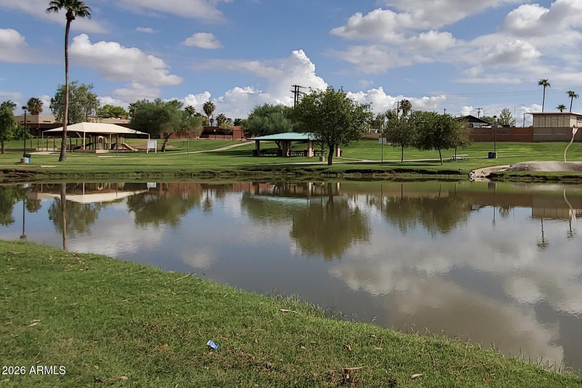 525 North Miller Road, Unit 239 Scottsdale, AZ 85257 - Photo 47 of 52 a view of a lake with houses in the background