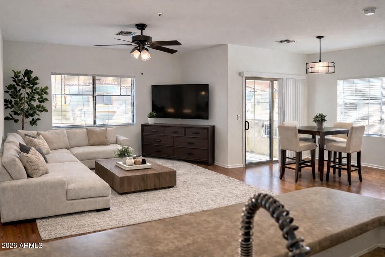 525 North Miller Road, Unit 239 Scottsdale, AZ 85257 - Photo 5 of 52 a living room with furniture flat screen tv and a large window