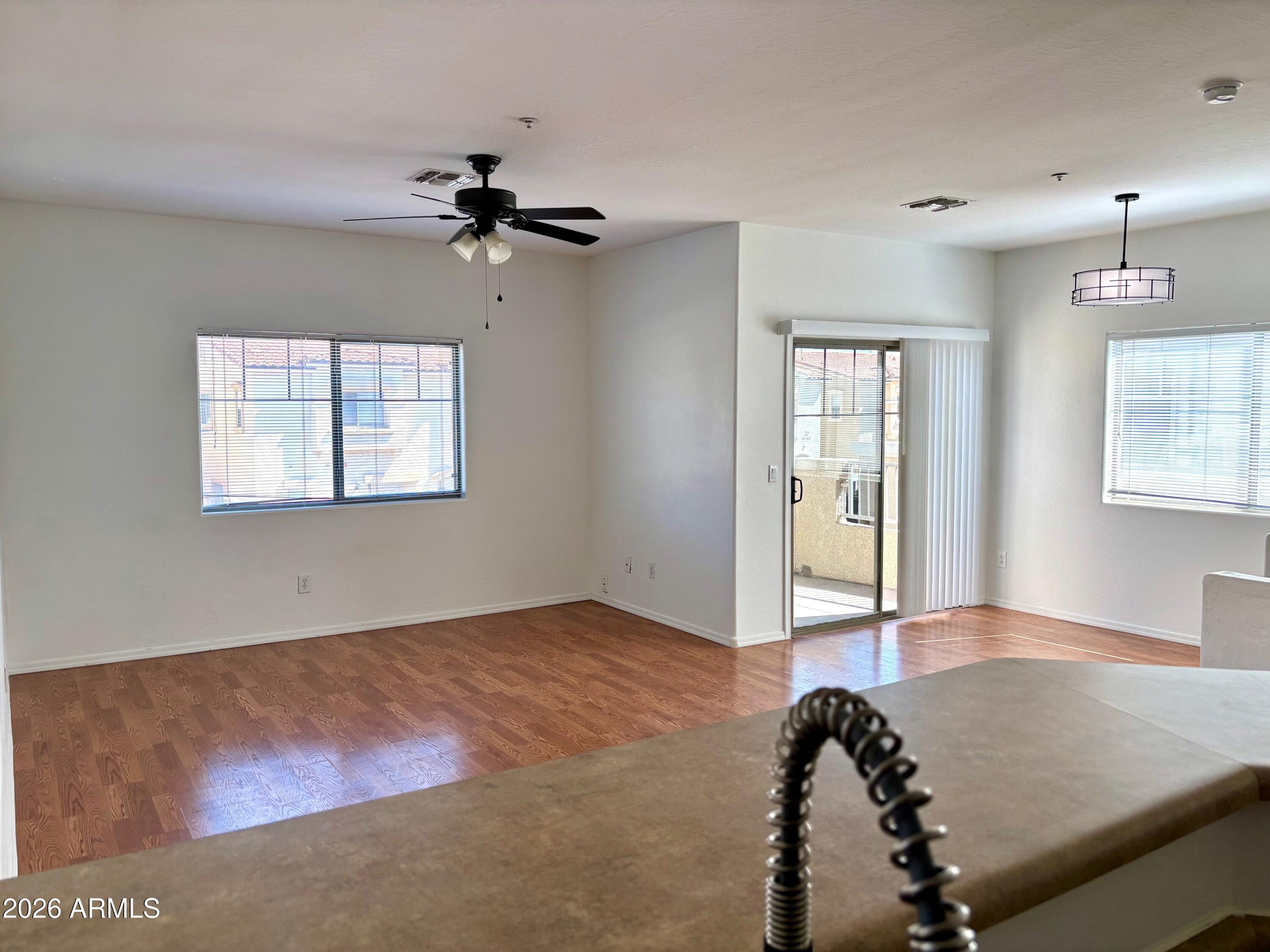 525 North Miller Road, Unit 239 Scottsdale, AZ 85257 - Photo 6 of 52 a view of a livingroom with a ceiling fan and window