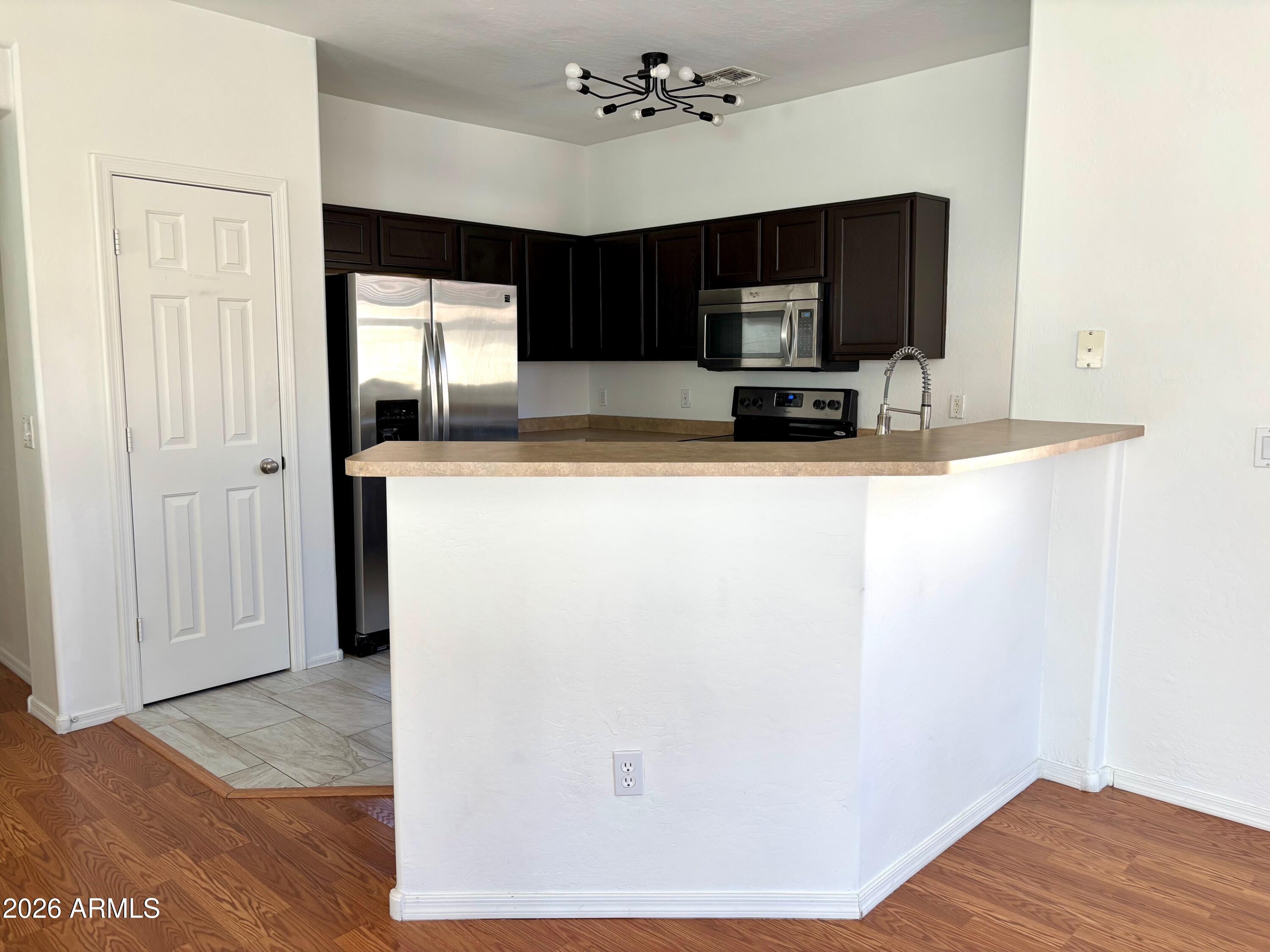 525 North Miller Road, Unit 239 Scottsdale, AZ 85257 - Photo 7 of 52 a view of kitchen with cabinets and wooden floor