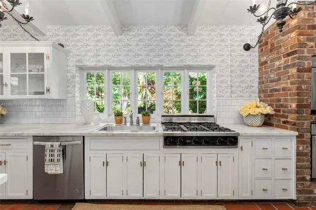 a kitchen with stainless steel appliances granite countertop a stove and a refrigerator