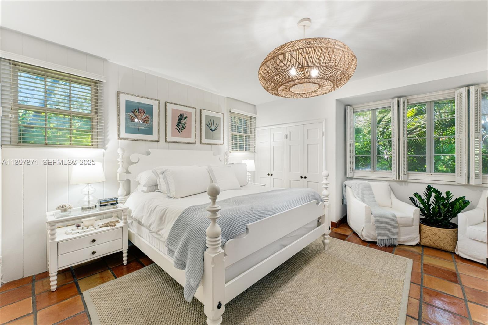 5950 Southwest 128th Street Pinecrest, FL 33156 - Photo 20 of 37 a bed room with a bed and a chandelier
