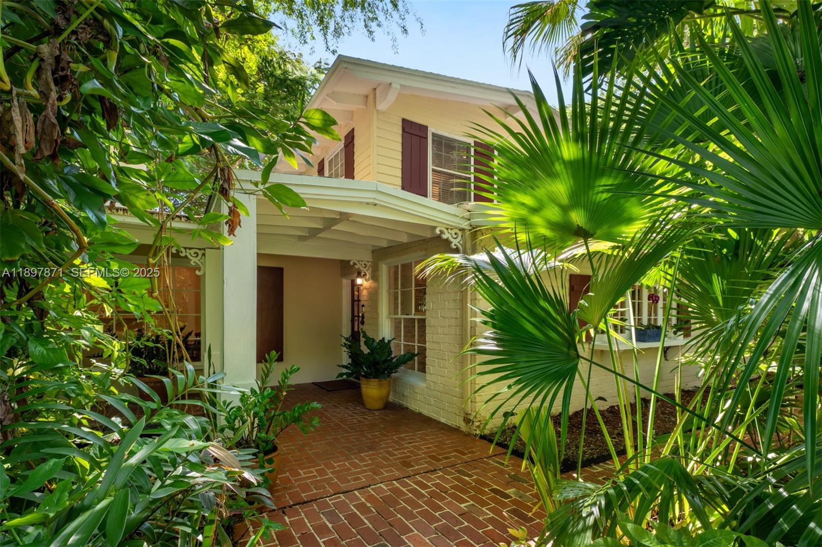 5950 Southwest 128th Street Pinecrest, FL 33156 - Photo 2 of 37 a view of a house with a plants