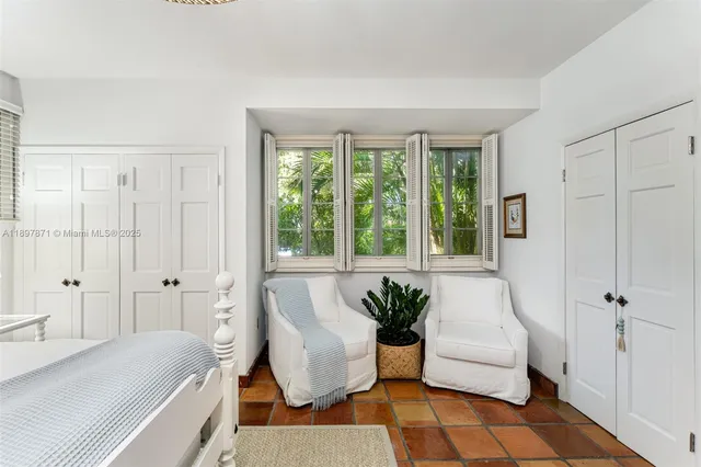 a bedroom with a large bed and a large window