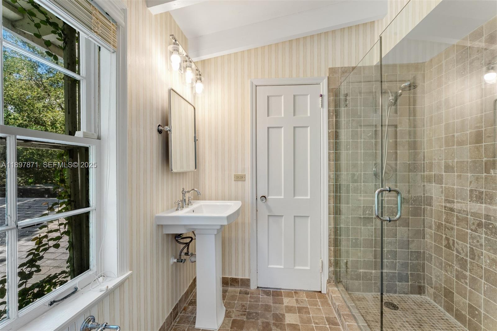 5950 Southwest 128th Street Pinecrest, FL 33156 - Photo 24 of 37 a bathroom with a sink a mirror and shower