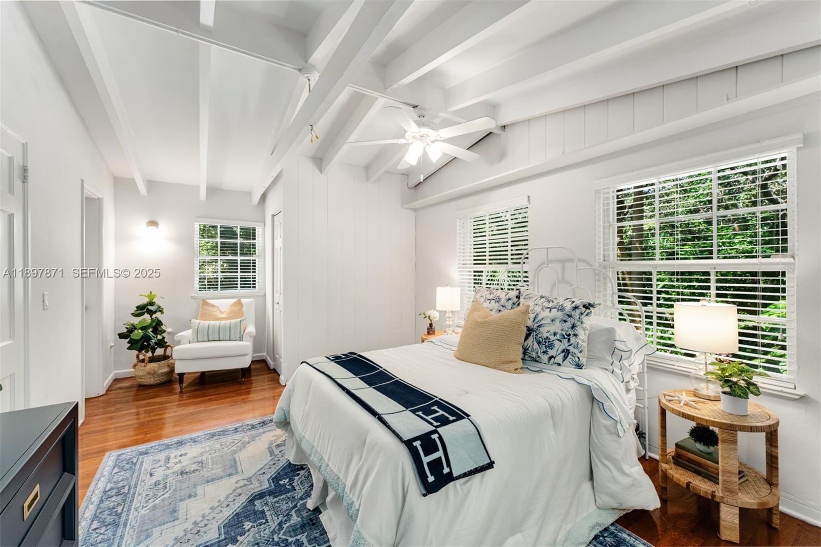 5950 Southwest 128th Street Pinecrest, FL 33156 - Photo 25 of 37 a bedroom with a bed and wooden floor