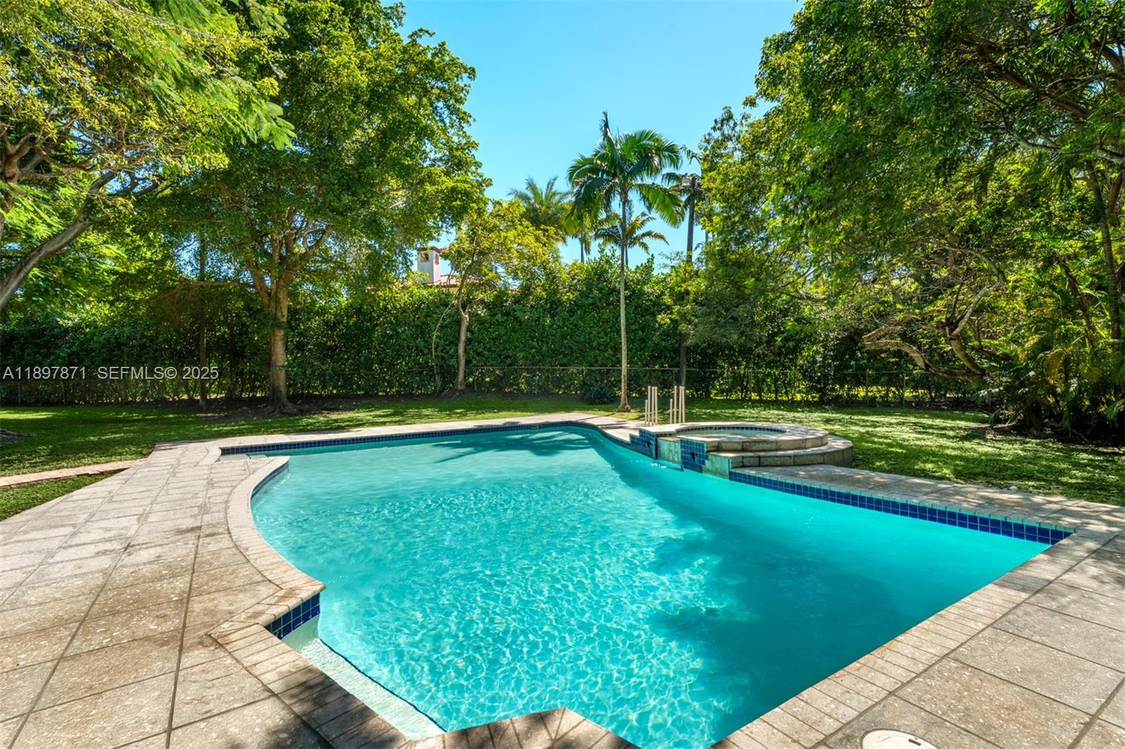 5950 Southwest 128th Street Pinecrest, FL 33156 - Photo 27 of 37 a view of a swimming pool with a yard