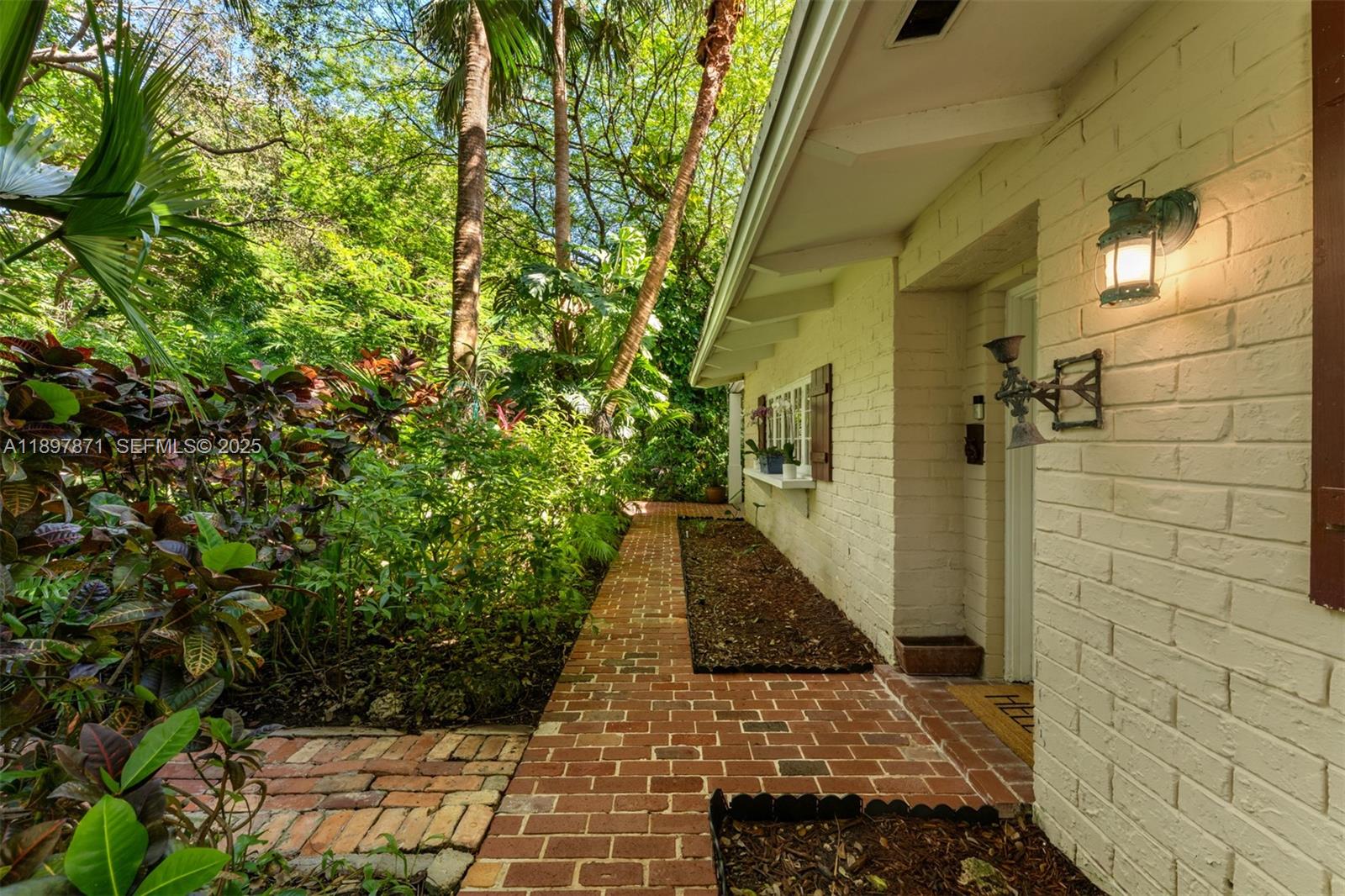 5950 Southwest 128th Street Pinecrest, FL 33156 - Photo 30 of 37 a view of a pathway both side of the house