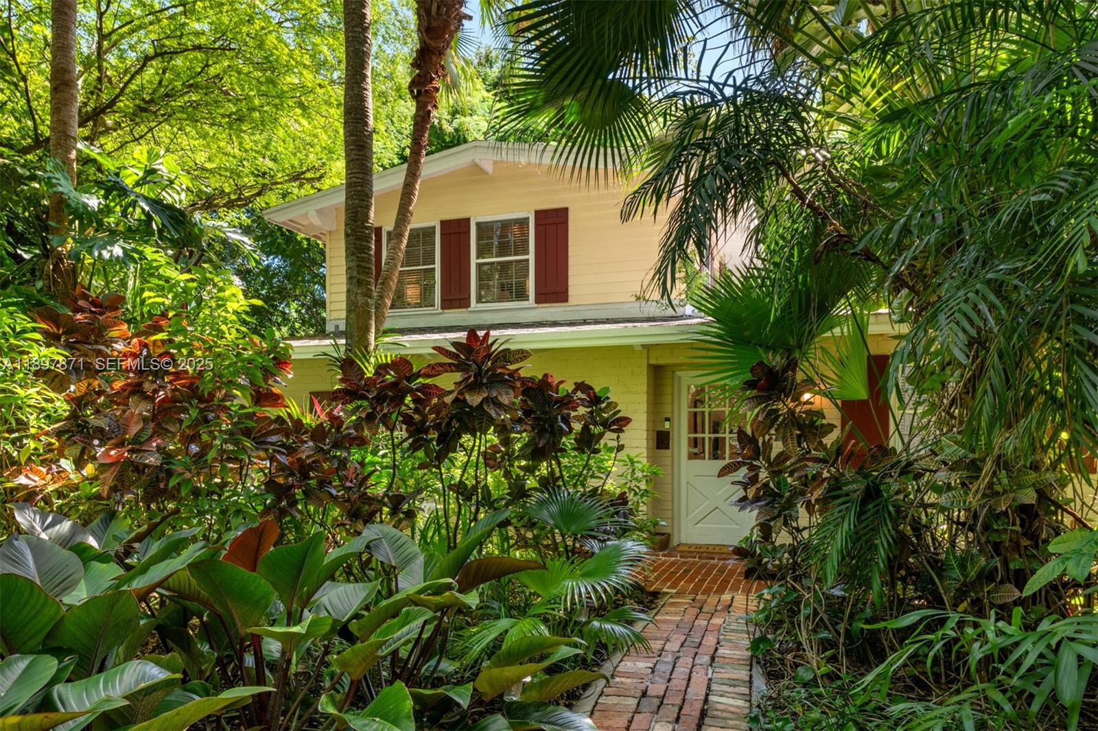 5950 Southwest 128th Street Pinecrest, FL 33156 - Photo 31 of 37 a front view of a house with a yard