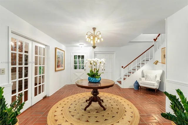 a living room with patio furniture and a large window