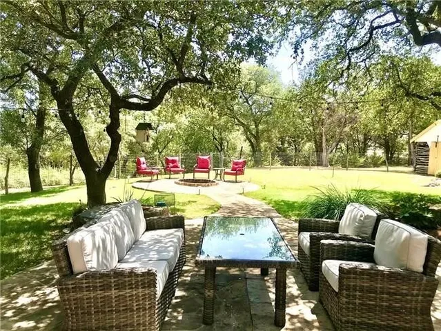 a view of patio with couches chairs and a yard