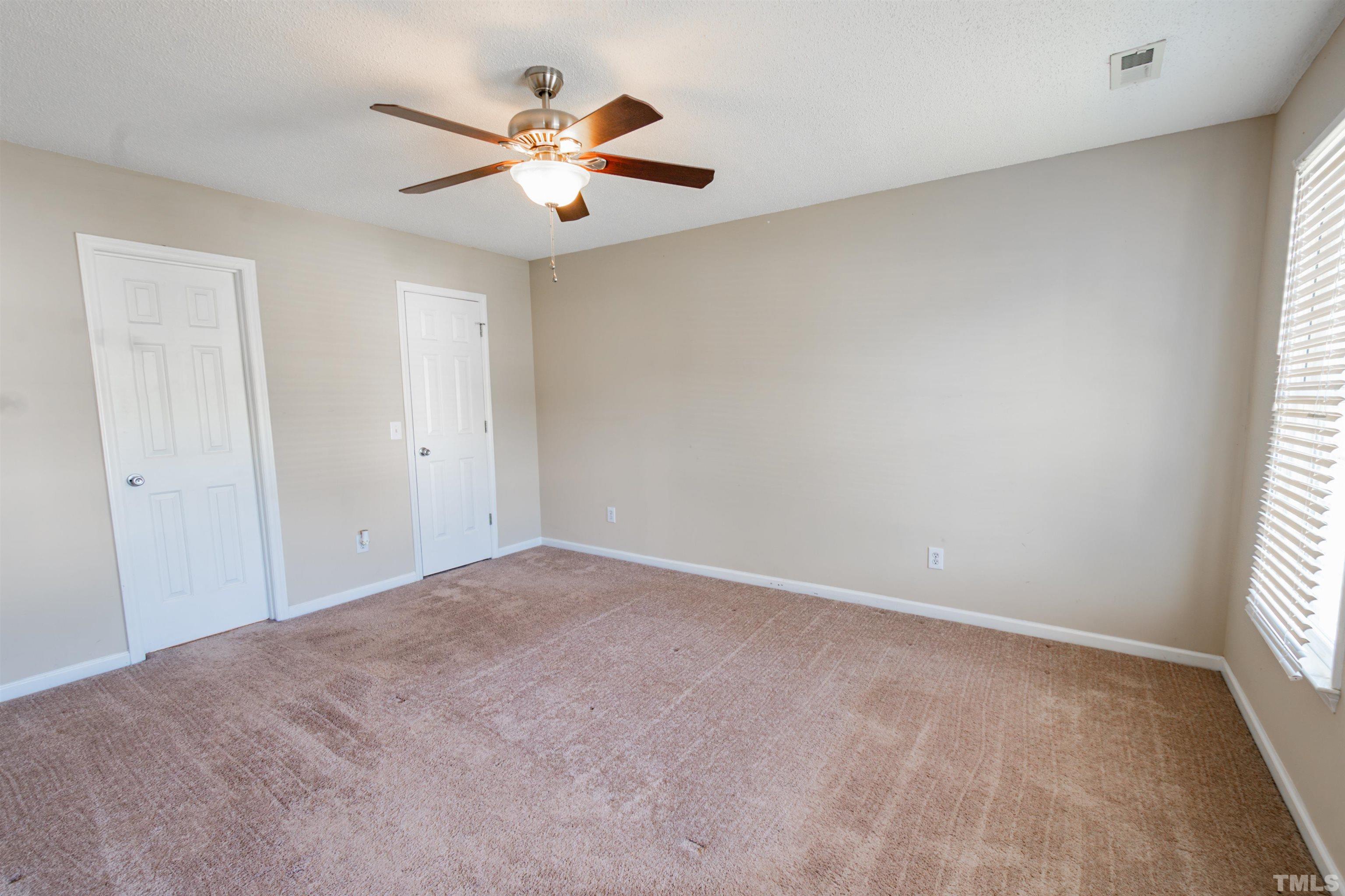 99 Windsor Drive Angier, NC 27501 - Photo 11 of 21 an empty room with windows and fan