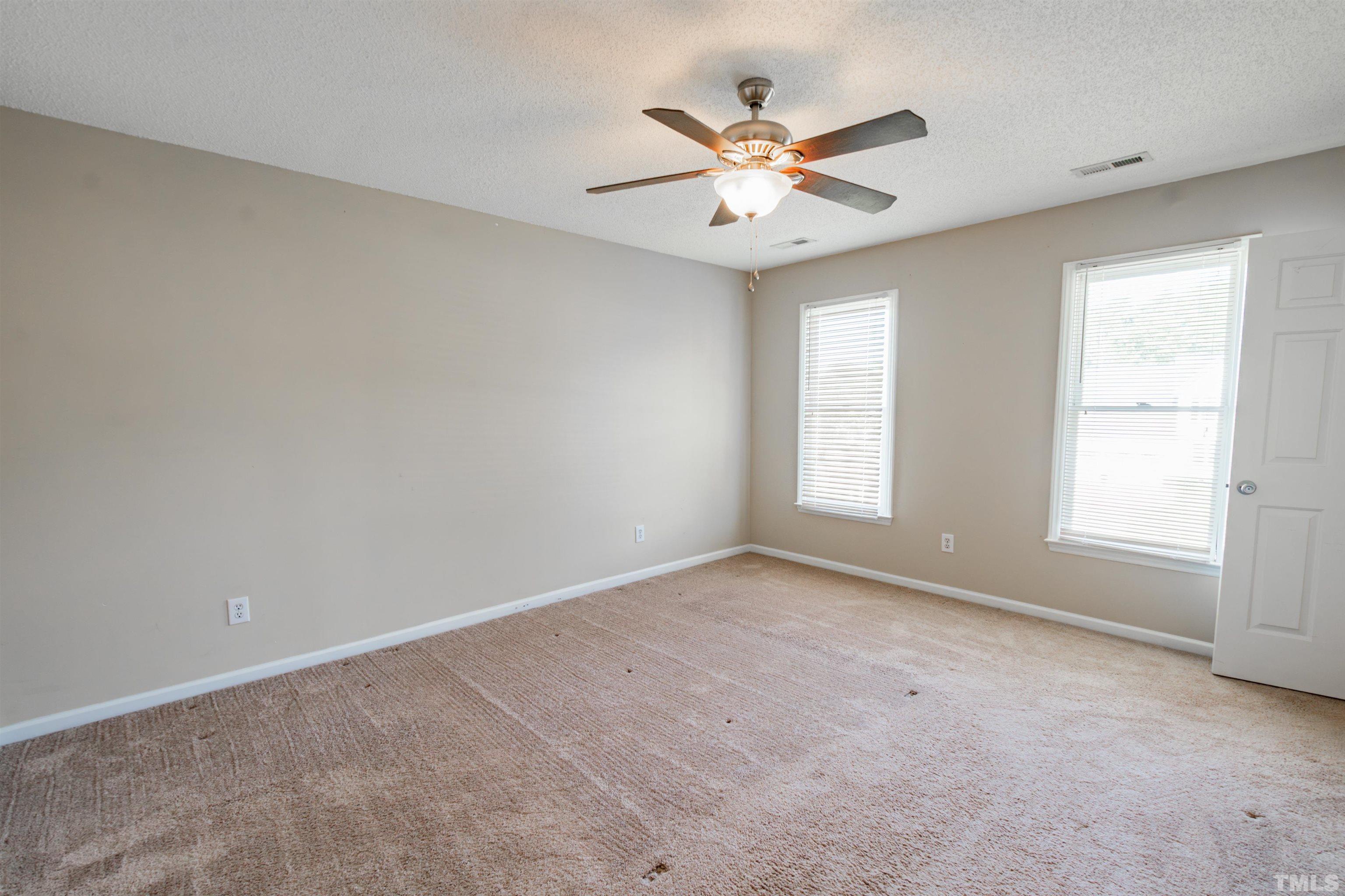 99 Windsor Drive Angier, NC 27501 - Photo 12 of 21 an empty room with windows and fan