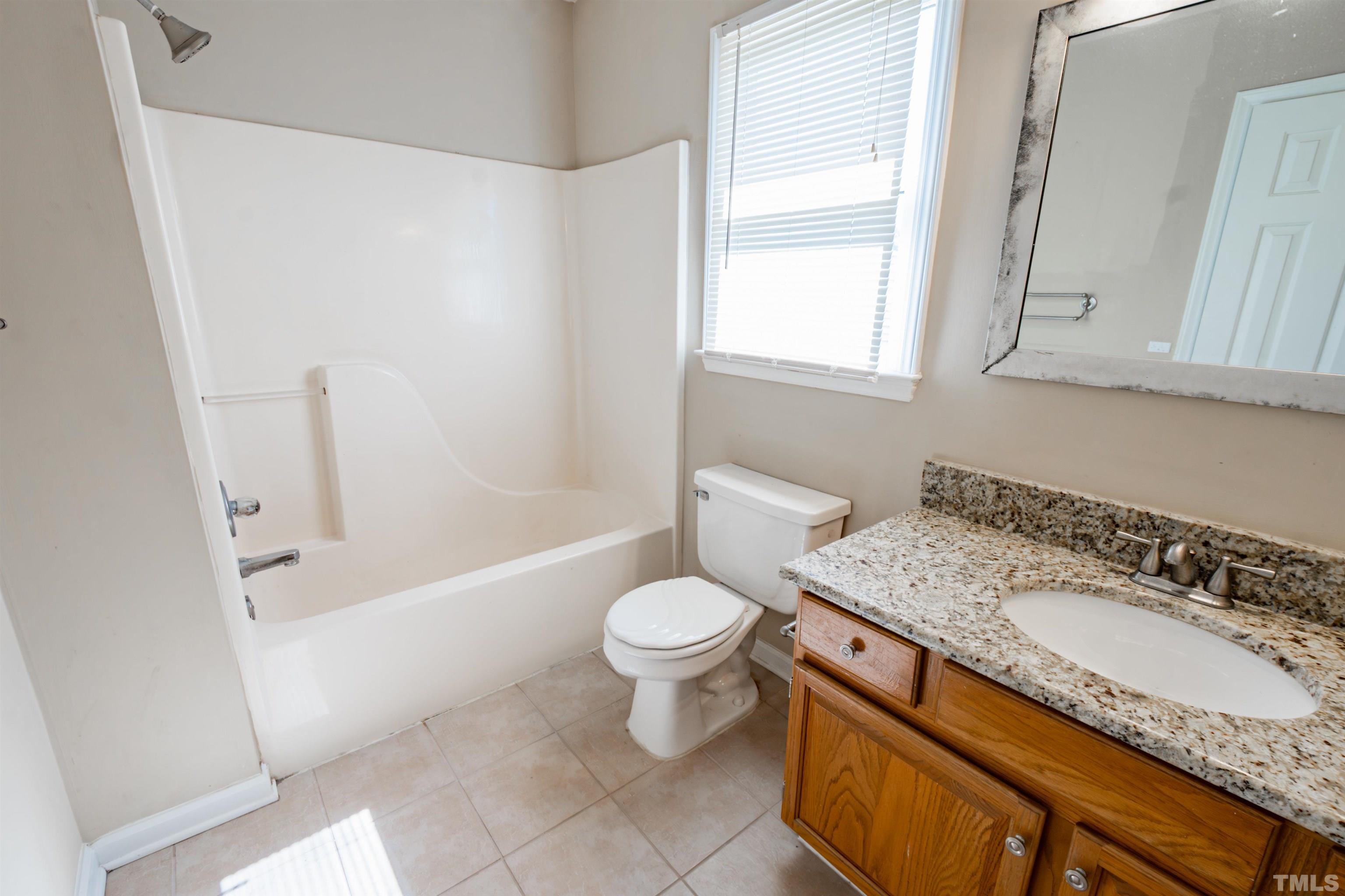 99 Windsor Drive Angier, NC 27501 - Photo 14 of 21 a bathroom with a granite countertop sink toilet and shower