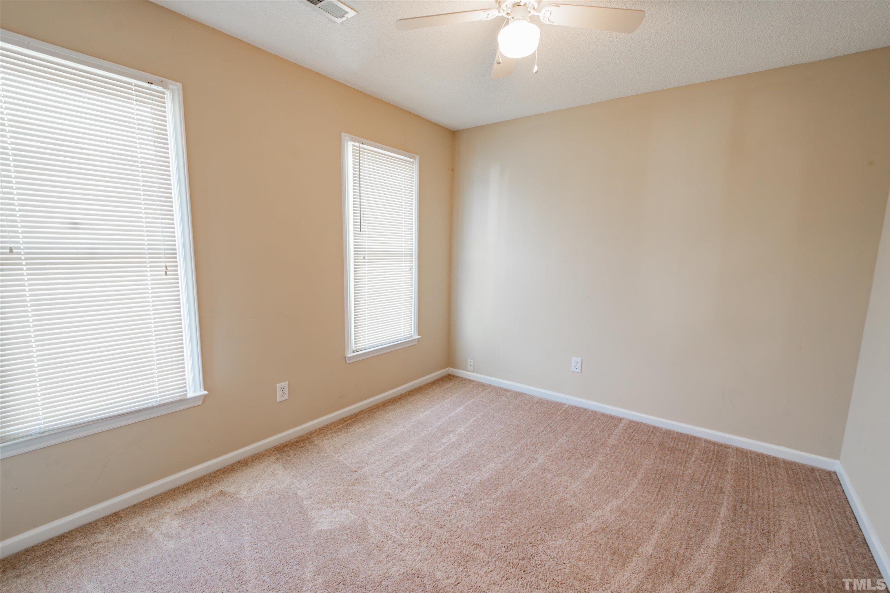 99 Windsor Drive Angier, NC 27501 - Photo 15 of 21 an empty room with windows