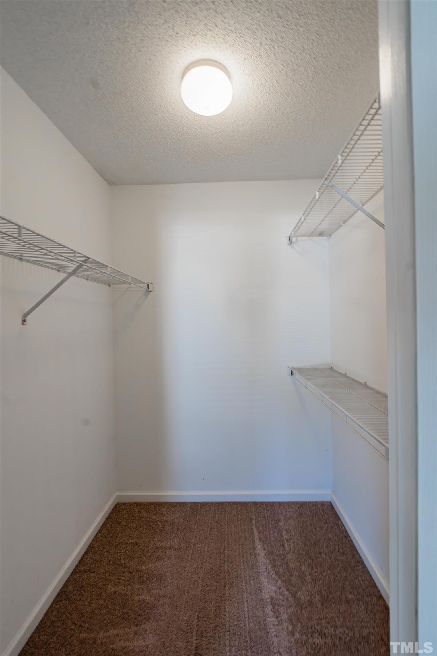 99 Windsor Drive Angier, NC 27501 - Photo 17 of 21 a view of a room with racks on the wall