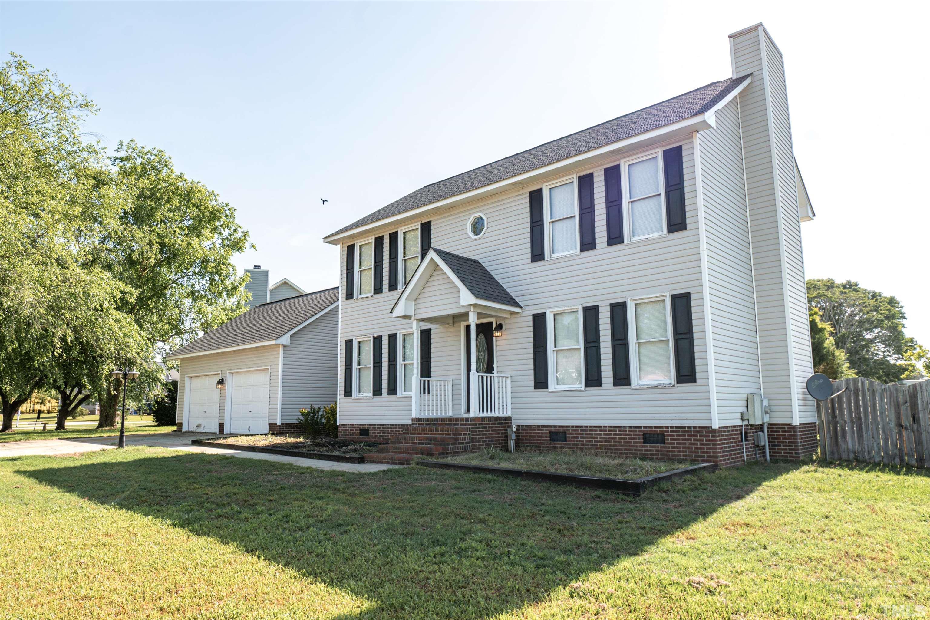 99 Windsor Drive Angier, NC 27501 - Photo 2 of 21 a front view of a house with a garden