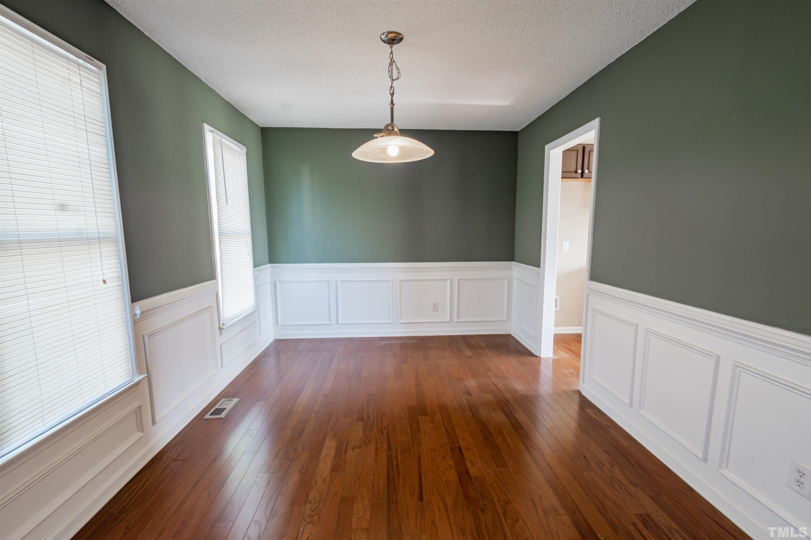 99 Windsor Drive Angier, NC 27501 - Photo 9 of 21 wooden floor in an empty room with a window