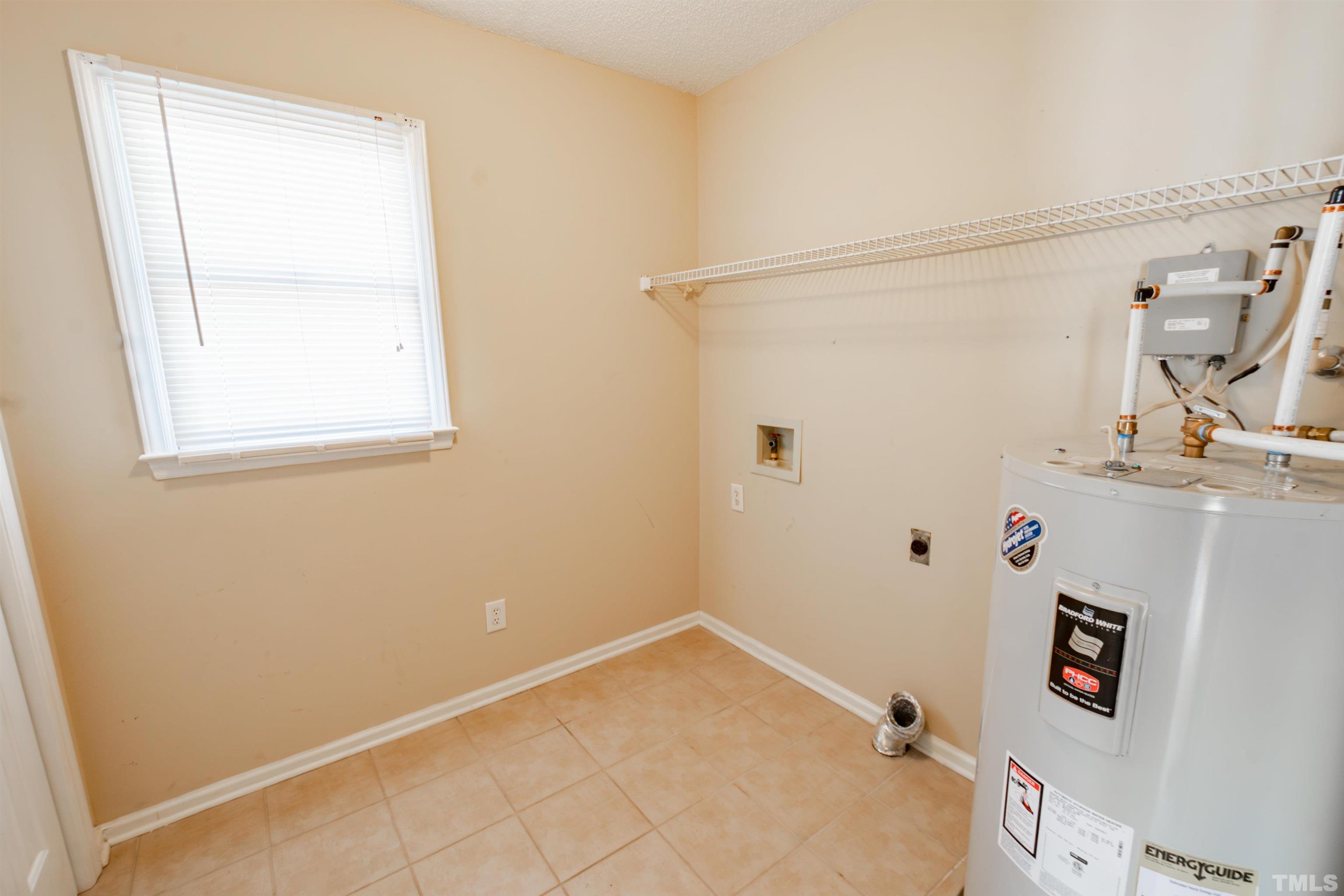99 Windsor Drive Angier, NC 27501 - Photo 10 of 21 a bathroom with a bathtub and a window