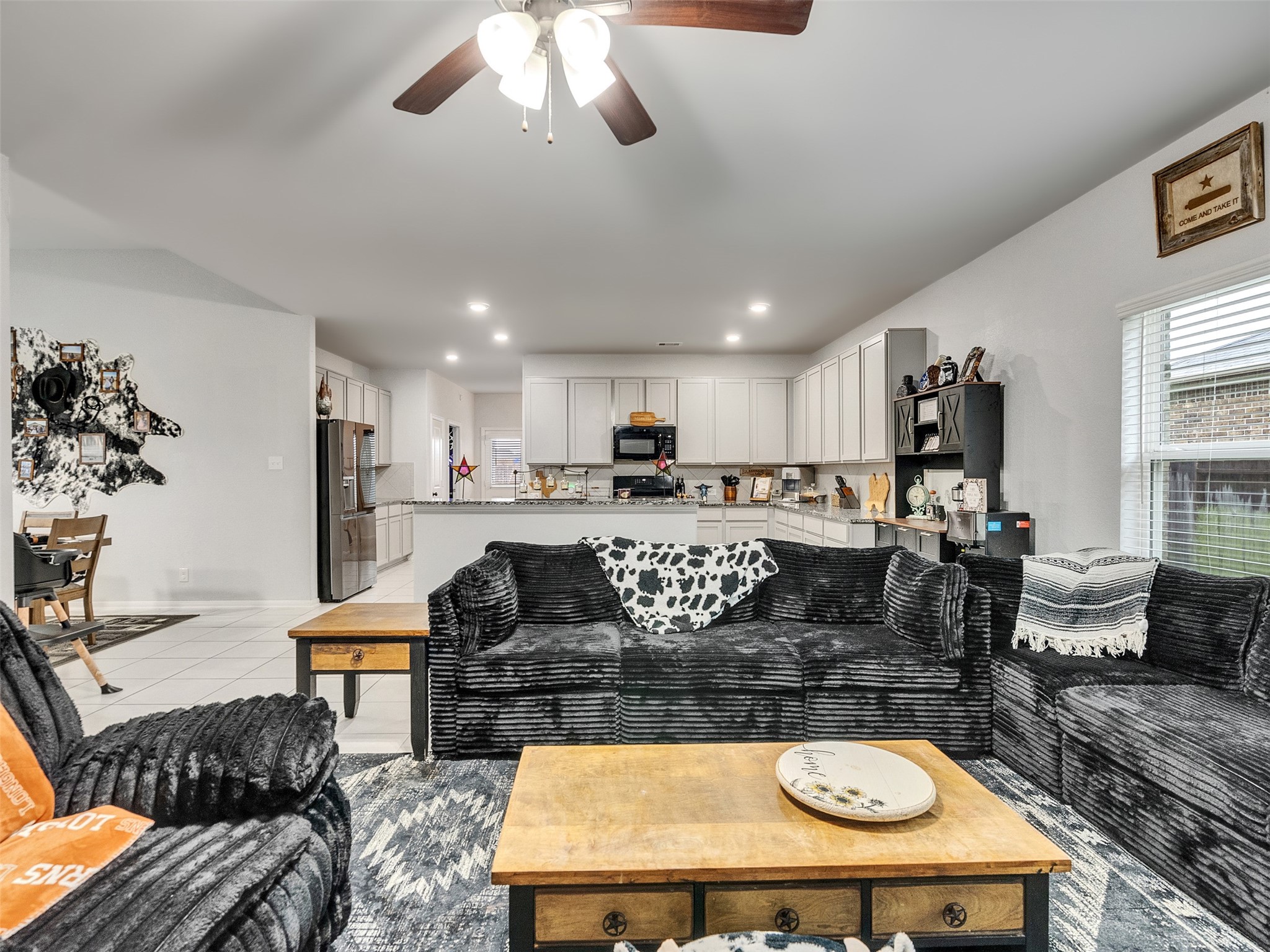 8719 Willet Street Baytown, TX 77521 - Photo 11 of 42 a living room with furniture kitchen view and a large window