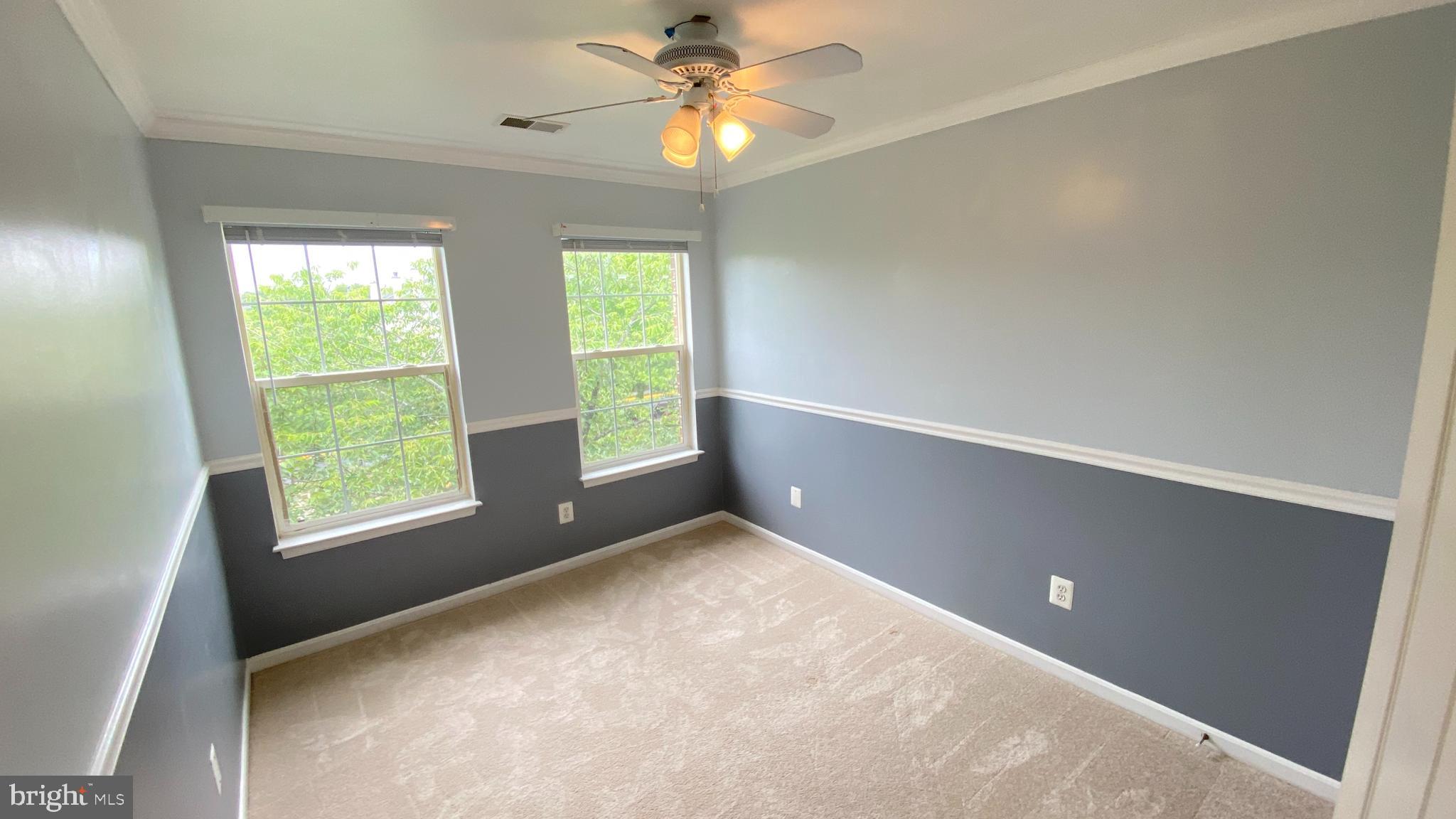 8231 Ramseur Place Manassas, VA 20109 - Photo 12 of 16 a view of an empty room with window and chandelier fan